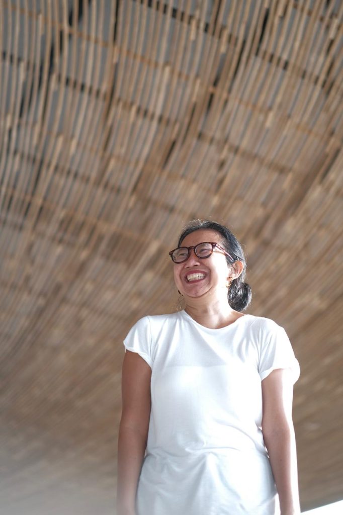 Happy woman wearing white top and smilling